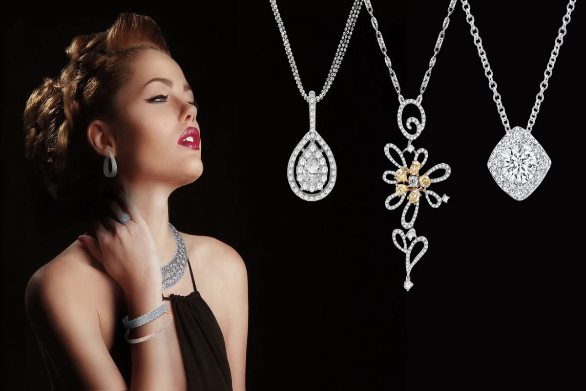 A woman looking at a necklace with a flower pendant.